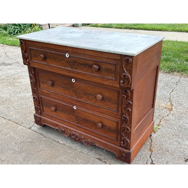 A beautiful example of solid wood 19th century furniture, this Empire style commode chest is sturdy and solid with...
