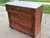 A beautiful example of solid wood 19th century furniture, this Empire style commode chest is sturdy and solid with...