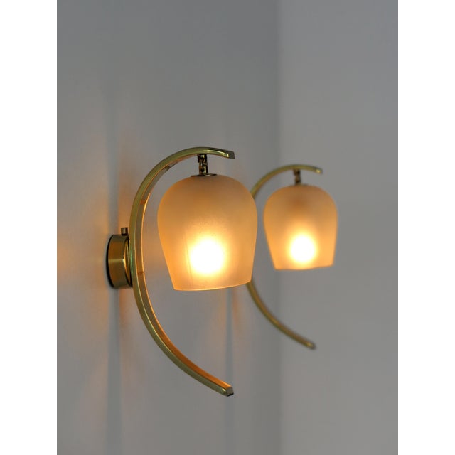 Pair of bell-shaped wall lamps designed by Pietro Chiesa and produced by Fontana Arte with a gilded brass structure and a...