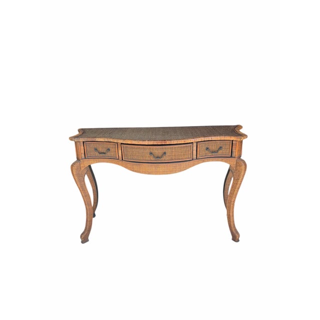 Offering this woven rattan top and drawer fronts, bamboo trim with grasscloth covering the legs and space around the...