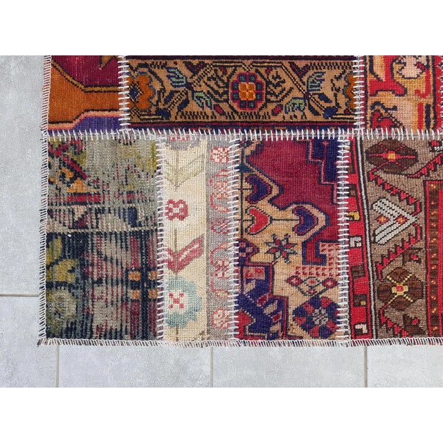 This is a vintage Turkish Oushak rug from the Mid 20th Century. The piece was hand-knotted.