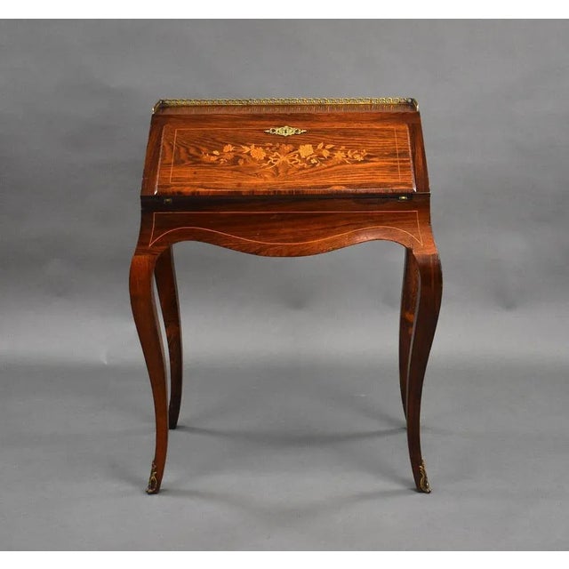 For sale is a good quality French rosewood Bureau De Dame. The top of the bureau has a nice brass gallery above a fall...