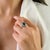 This elegant halo ring features 1 emerald-cut natural green emerald totaling 1.06 carats, set in 14k white gold. The...