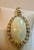 Approximately 36 Carat Oval Ethiopian Opal & Diamond Pendant 14 Karat Yellow Gold Necklace with Chain This spectacular...