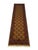 A warm terracotta-ochre field gives this runner its distinctive color. Two rows of repeating octagonal gul motifs run its...
