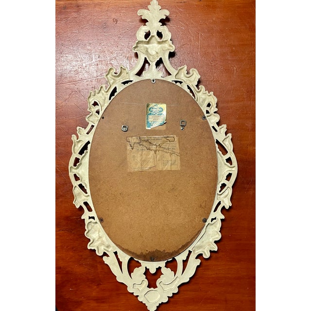 This is a gorgeous, very ornate, 1950's Fashion Plate Mirror. The materials are resin and mirror. Very stunning wall...