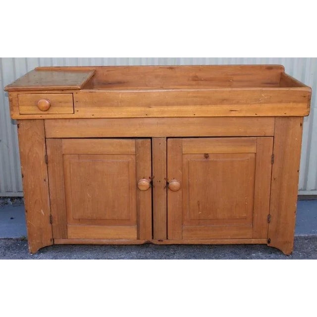 This 19thc pine dry sink cabinet with a drawer is in fine condition. It has a amazing old refinished surface with a nice...