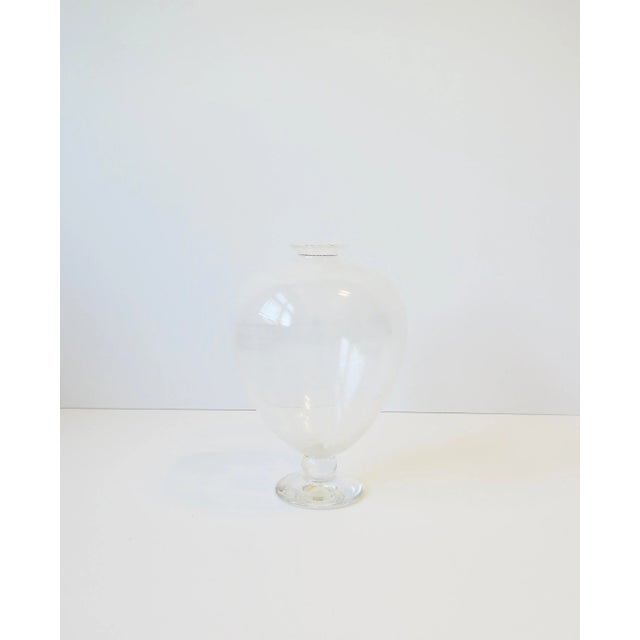A beautiful clear/transparent and white urn form art glass vase, circa late-20th century. Piece is transparent with very...