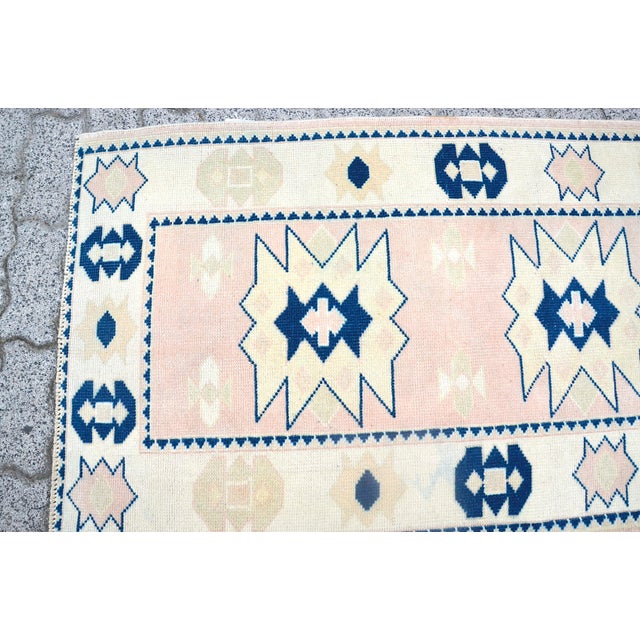 This is a vintage Turkish Oushak rug from the 1960s. The piece was hand-knotted.