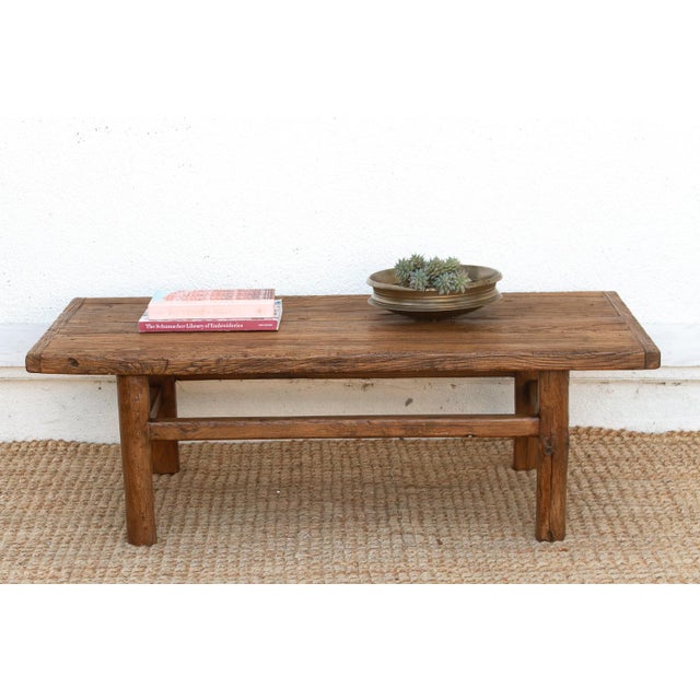 This charming coffee table is a soulful anchor for the curated living space. Handcrafted from solid reclaimed elm, this...