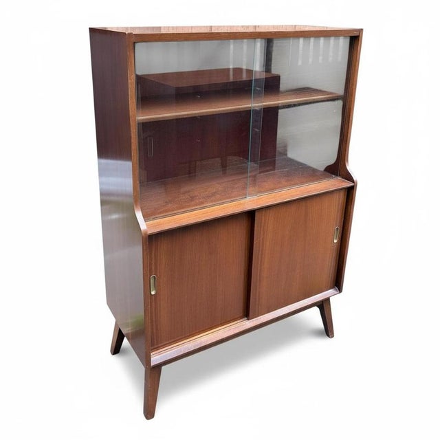 This mid century display cabinet by Beautility combines style and function to enhance your living space with timeless...