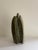 Hand carved abstract stone sculpture. Shades of green, brown & tan. Artist signed.