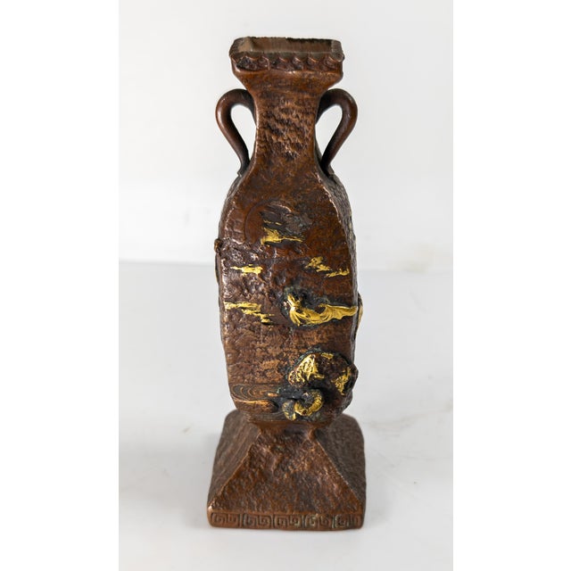 We are selling this interesting Japanese ceramic porcelain vase. This vase is styled after a Mixed Metal bronze vase with...