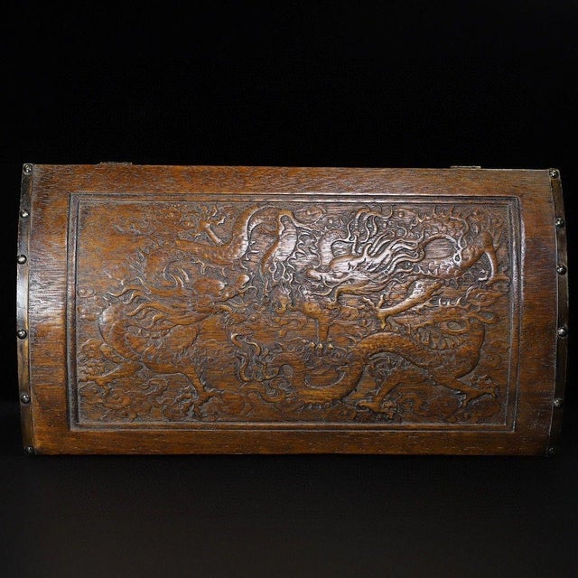 This handsome dome-top hardwood treasure chest is expertly carved with a dynamic twin dragons chasing pearl scene across...