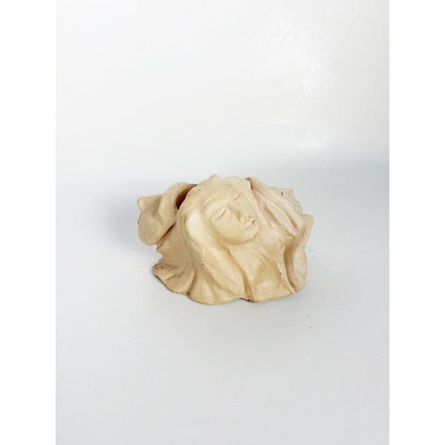 French sculptural piece dating from the 1980s, crafted in raw, unglazed clay. The organic composition features several...
