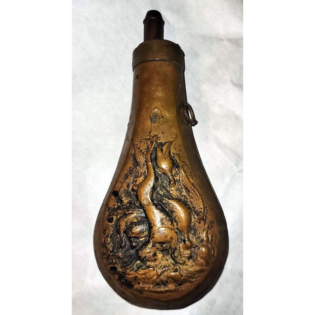 19c powder flask from the Civil War era, spring dispenser on top still working, solid copper, animal motif in relief. Keep...