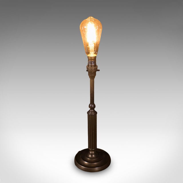 This is a vintage table lamp base. An English, nickel brass decorative accent light, dating to the late 20th century,...