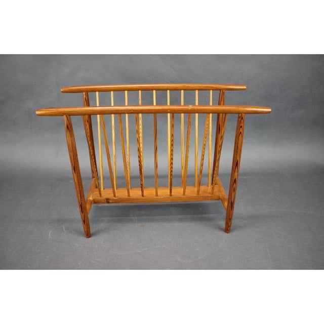 This elegant vintage magazine rack was made in Czechoslovakia during the 1950s. Its open-frame construction combines...