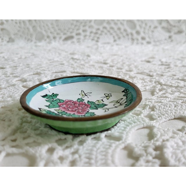 A small cloisonne dish, the perfect size used as a ring dish or to hold a tea bag. It measures 2 3/4" diameter x 1/2".
