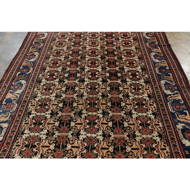 Made with hand-knotted wool circa 1920-1930, this 7x10 antique Persian rug is a powerful exemplar of the Lori (Luri)...