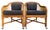 A handsome pair of vintage rattan lounge chairs featuring a classic burnt bamboo finish, faux bamboo styling, woven cane...