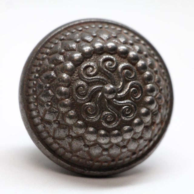 This steel swirl door knob was made in 1900 catalog. It is part of the E-14700 group. It has a swirled center and a black...