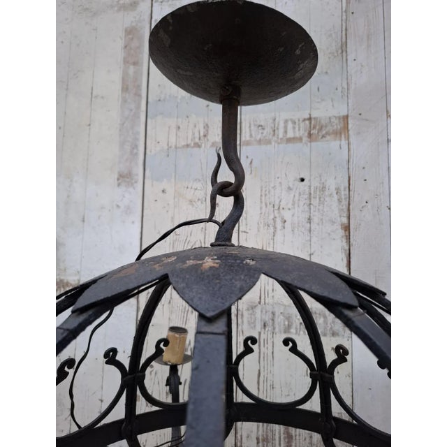 A striking Dutch wrought-iron chandelier from the early 20th century, strongly reminiscent of the Amsterdam School and...