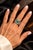 Vintage statement ring crafted in 14 karat white gold and centered with a natural emerald cabochon measuring approximately...