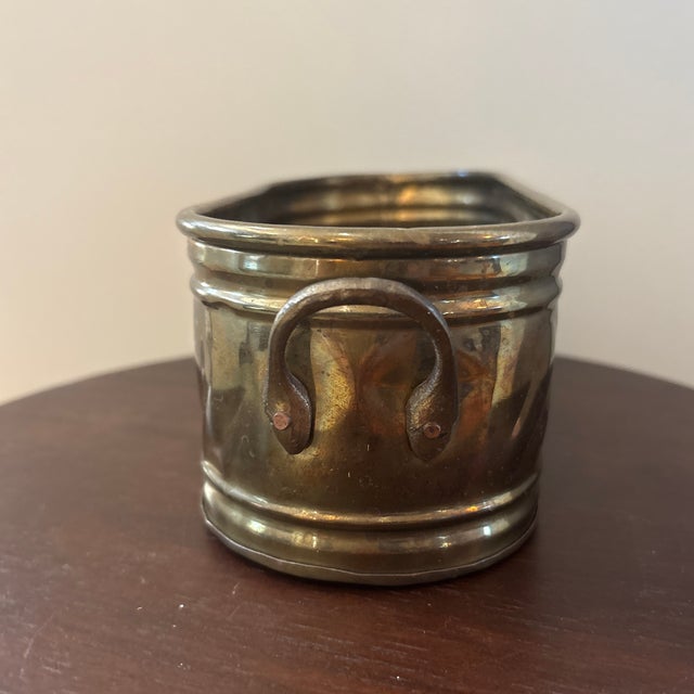 Decorative 1980s vintage brass oval cachepot or jardinière featuring an elongated form, applied ring handles and handsome...