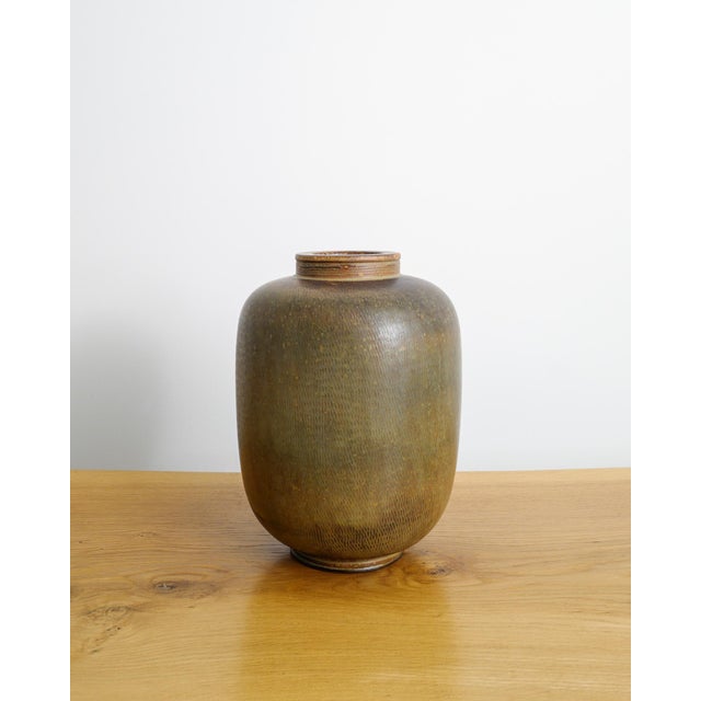 A unique and large swedish mid century "farsta" stoneware urn vase in a decorative brown green glaze designed by wilhelm...