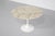 "Tulip" dining table, 107 cm, with a round Calacatta Gold marble top and white base, the brand's best-selling marble....