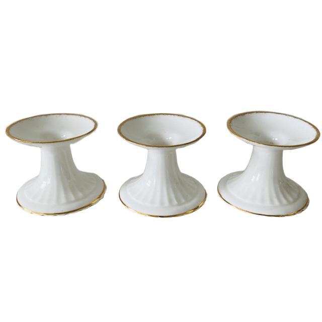 A set of three low Val d’Or porcelain candlesticks, marked Royal Albert. The porcelain candlesticks are in very good...