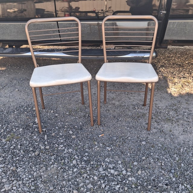 Beautiful folding chairs by Hamilton Cosco, with a rosegold metal frame and cream colored seat. Classic 1950s, with...