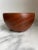 A simple handcrafted teak wood bowl with elegant form and rich wood grain. The bowl is marked, Made in Norway and numbered...
