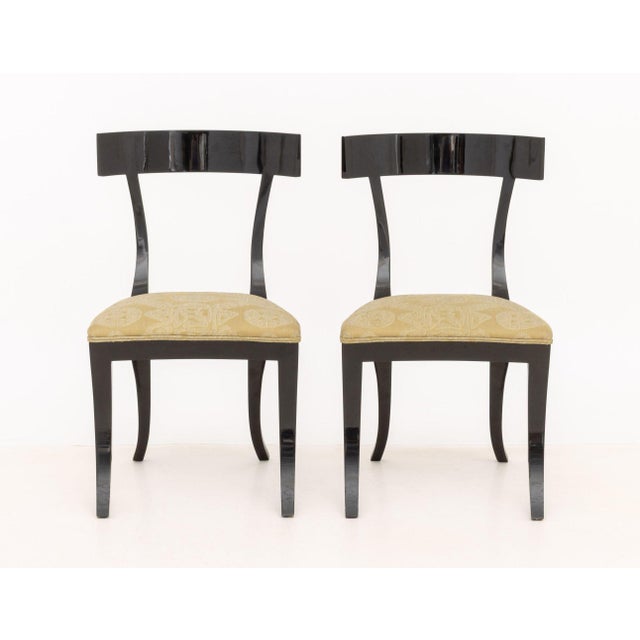 Pair of Contemporary Ebonized Wood Klismos Dining Chairs, with geometric light green upholstered seat on curved tapered...