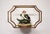 Set of three graduated gold-tone metal and clear glass floating wall shelves featuring curved open-frame silhouettes and...