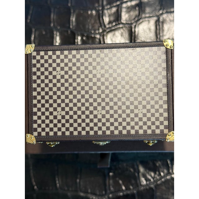 This magnificent Louis Vuitton paperweight is crafted entirely from lithographed metal. It features the letter "T" within...