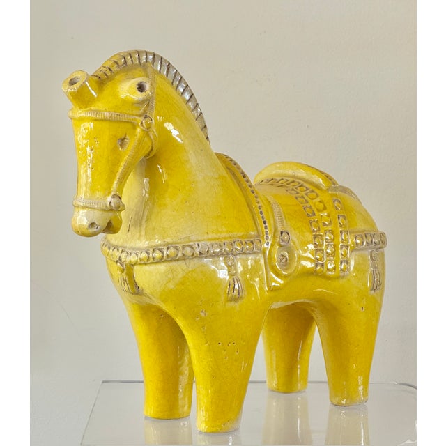 A large terracotta horse figure with yellow glaze. Marked on underside of foot “4738 D Italy”. Attributed to Aldo Londi...
