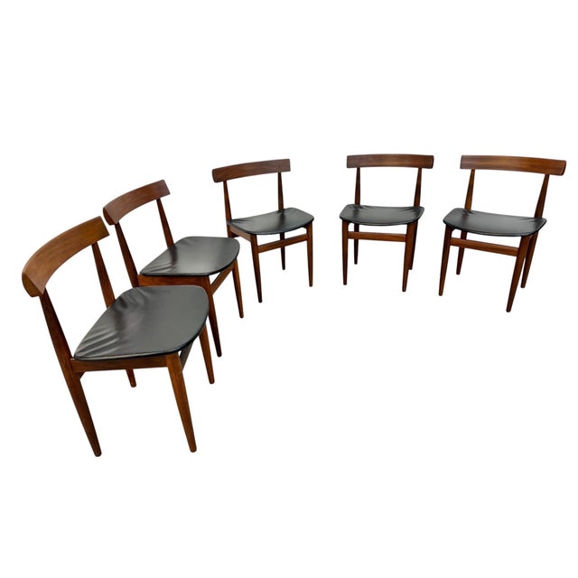 A rare and highly collectible set of Mid-Century Danish Modern Hans Olsen Roundette teak nesting chairs, showcasing the...