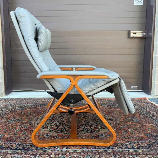 A mid century modern Plycraft Zero Gravity lounge chair in gray leather and canvas with a triangular bentwood base. Two...