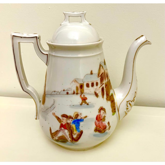 Limoges tea pot designed by Oscar Gutherz. Adorned with rare images of children playing, one side features a springtime...