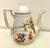 Limoges tea pot designed by Oscar Gutherz. Adorned with rare images of children playing, one side features a springtime...