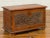 An Indonesian vintage wooden blanket chest from the mid-20th century, with floral carved front, dovetailed construction...
