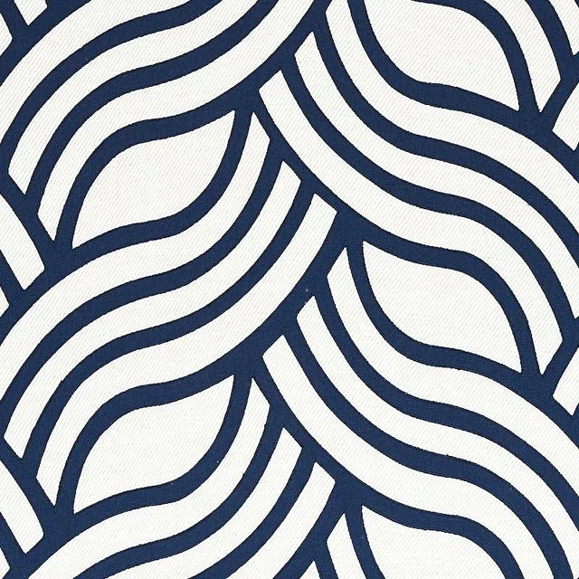 Curvaceous, undulating lines of appliqu√© create a striking contrast with a chunky, solid twill ground for a laid-back...