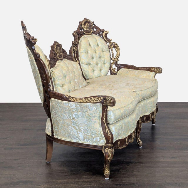 This beautiful loveseat features an elegant carved wood frame with detailed scrollwork and a unique triple backrest...