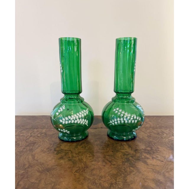 Fine quality pair of antique green glass shaped vases, having a quality pair of antique green glass vases decorated with...