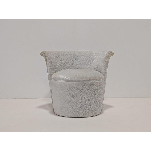 This elegant low-back pouf with subtle tufting and delicate silver leaf.carving adds a touch of femininity to any room....