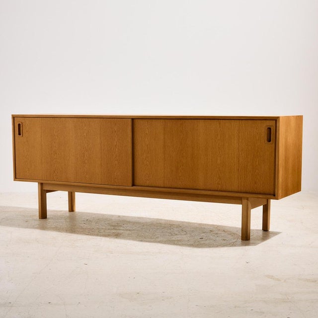 A true gem of design history from the 1960s reflecting the spirit of Danish design. ‘Model 21’ oak sideboard designed by...