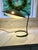 A true mid-century modern desk lamp for Lightolier. The green enamel shade sits on top of a graceful curved brass arm with...