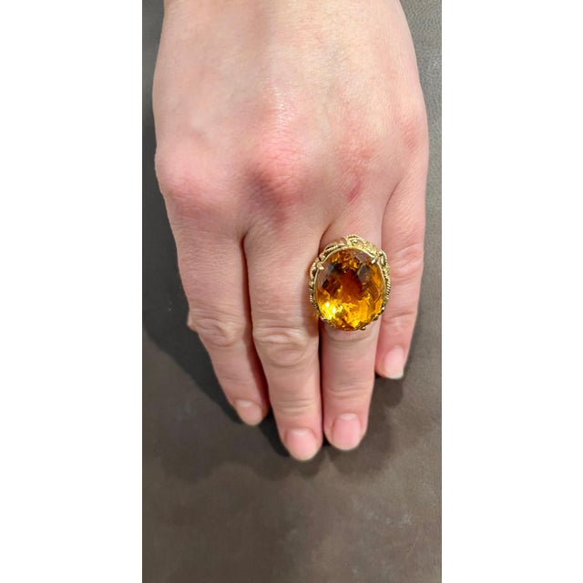 Approximately 20 Carat Natural Oval Citrine Cocktail Ring in 14 Karat Yellow Gold, Estate This is a ring which has a...